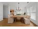 Open dining area featuring modern chandelier, wood flooring and bright windows at 1640 Legendary Ln, Morrisville, NC 27560