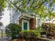 Charming brick home featuring a blue front door adorned with a wreath and surrounded by lush landscaping at 1640 Legendary Ln, Morrisville, NC 27560