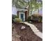 Charming brick home featuring a blue front door adorned with a wreath and surrounded by lush landscaping at 1640 Legendary Ln, Morrisville, NC 27560