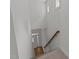 Bright hallway with white walls, hardwood entry, carpeted stairs, and natural light from above windows at 1640 Legendary Ln, Morrisville, NC 27560