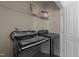 Well-lit laundry room with black front-load washer and dryer and wire rack shelving at 1640 Legendary Ln, Morrisville, NC 27560