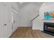 Bright living room featuring hardwood floors, fireplace, and elegant double front door with decorative glass at 1640 Legendary Ln, Morrisville, NC 27560