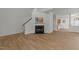 Bright living room features hardwood floors, a fireplace, and staircase, creating a cozy and inviting atmosphere at 1640 Legendary Ln, Morrisville, NC 27560