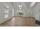 Bright living room featuring large windows, vaulted ceilings, and hardwood floors, offering a spacious feel at 1640 Legendary Ln, Morrisville, NC 27560