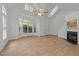 Bright living room featuring large windows, vaulted ceilings, and hardwood floors, offering a spacious feel at 1640 Legendary Ln, Morrisville, NC 27560