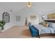 Spacious main bedroom with a king-size bed, blue ottoman, and elegant decor for relaxation at 1640 Legendary Ln, Morrisville, NC 27560