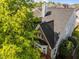 A shingled roofline on a home surrounded by mature trees and manicured landscaping at 1640 Legendary Ln, Morrisville, NC 27560