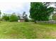 Large grassy backyard featuring a storage shed, mature trees, and a well-maintained lawn at 1744 Prince Edward Dr, Elon, NC 27244