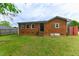 Brick house with a large, green backyard and small porch with metal railings at 1744 Prince Edward Dr, Elon, NC 27244