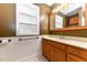 Brown bathroom featuring white shelving and vanity at 1744 Prince Edward Dr, Elon, NC 27244