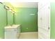Bright bathroom featuring a double vanity, ample storage, and light green walls at 1744 Prince Edward Dr, Elon, NC 27244
