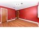 Red bedroom featuring wood floors and two doors at 1744 Prince Edward Dr, Elon, NC 27244