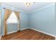 Blue bedroom featuring wood floors and curtains at 1744 Prince Edward Dr, Elon, NC 27244