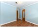 Blue bedroom featuring wood floors and doors at 1744 Prince Edward Dr, Elon, NC 27244