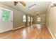 Large bonus room featuring hardwood floors, multiple windows, and a door leading to the exterior at 1744 Prince Edward Dr, Elon, NC 27244
