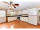 Bright eat-in kitchen with white cabinetry, black countertops and appliances, and plenty of counter space at 1744 Prince Edward Dr, Elon, NC 27244