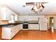 Well-lit kitchen featuring ample white cabinetry, modern appliances, and a large window over the sink at 1744 Prince Edward Dr, Elon, NC 27244