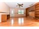 Spacious living room with hardwood floors, a brick fireplace, and built-in bookshelves for stylish storage at 1744 Prince Edward Dr, Elon, NC 27244