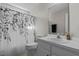 Bright bathroom features a modern vanity and a shower with a decorative curtain at 20 Sanders Rd, Benson, NC 27504