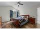 Bedroom with wood flooring, vaulted ceiling, ceiling fan, and a large bed at 20 Sanders Rd, Benson, NC 27504