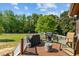 Expansive deck with grill and seating overlooks the large, well-maintained backyard at 20 Sanders Rd, Benson, NC 27504