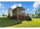 Exterior side view of house showcasing a screen porch and deck overlooking the green backyard at 20 Sanders Rd, Benson, NC 27504