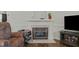 Bright living room features a classic fireplace with mantel, adding warmth and charm at 20 Sanders Rd, Benson, NC 27504