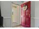 Welcoming red front door with storm door and a playful decorative sign at 20 Sanders Rd, Benson, NC 27504