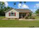 Charming home featuring tidy landscaping, red shutters, and a cozy front porch at 20 Sanders Rd, Benson, NC 27504