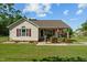 Charming home featuring tidy landscaping, red shutters, and a cozy front porch at 20 Sanders Rd, Benson, NC 27504