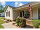 A cozy front porch featuring vibrant landscaping and seating at 20 Sanders Rd, Benson, NC 27504