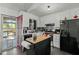 A kitchen with stainless steel appliances, a kitchen island, and plenty of counter space at 20 Sanders Rd, Benson, NC 27504