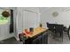 Kitchen island with butcher block top next to pantry doors for storage and meal prep at 20 Sanders Rd, Benson, NC 27504
