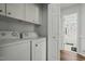 The laundry room leads to a bathroom with a shower and tiled floors at 20 Sanders Rd, Benson, NC 27504