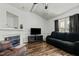 Inviting living room with a fireplace, laminate wood floors, and comfortable seating for relaxation at 20 Sanders Rd, Benson, NC 27504