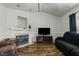 Inviting living room with a fireplace, laminate wood floors, and comfortable seating for relaxation at 20 Sanders Rd, Benson, NC 27504