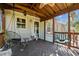Cozy screened porch featuring hanging chairs and wood floors, ideal for relaxation and outdoor enjoyment at 20 Sanders Rd, Benson, NC 27504