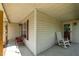 Covered porch with rocking chair and side chairs, perfect for relaxing outdoors at 20 Sanders Rd, Benson, NC 27504