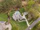 Drone shot showcases the elegant home, pool, well-manicured landscaping, and circular driveway at 2000 Silverleaf Dr, Youngsville, NC 27596