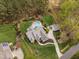 Aerial view of a beautiful home with a pool, lush landscaping, and mature trees on a spacious lot at 2000 Silverleaf Dr, Youngsville, NC 27596