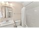 Clean bathroom featuring a shower with curtain, a single sink vanity, and neutral tile flooring at 2000 Silverleaf Dr, Youngsville, NC 27596
