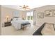 Bright bedroom featuring a ceiling fan, a large window with natural light and neutral carpeted floor at 2000 Silverleaf Dr, Youngsville, NC 27596