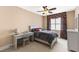 Cozy bedroom with a bed, desk, chair and floral curtains at 2000 Silverleaf Dr, Youngsville, NC 27596