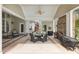 Inviting covered patio with ceiling fans, a brick fireplace, and comfortable seating for outdoor relaxation at 2000 Silverleaf Dr, Youngsville, NC 27596