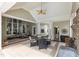 Inviting covered patio with ceiling fans, a brick fireplace, and comfortable seating for outdoor relaxation at 2000 Silverleaf Dr, Youngsville, NC 27596