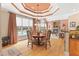Open dining area with views of the pool and a stone fireplace creating a seamless indoor-outdoor feel at 2000 Silverleaf Dr, Youngsville, NC 27596