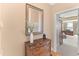 Entryway with wood floors, chest, vase of white flowers, mirror, and hallway into another room at 2000 Silverleaf Dr, Youngsville, NC 27596