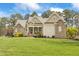 Stunning stone and siding home featuring a large manicured lawn and classic architectural details at 2000 Silverleaf Dr, Youngsville, NC 27596
