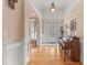 Elegant foyer with hardwood floors, wainscoting, and a grand arched entryway leading to other rooms at 2000 Silverleaf Dr, Youngsville, NC 27596