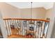 Open foyer features wrought iron railing and a view of the living room with fireplace and built-in bookshelves at 2000 Silverleaf Dr, Youngsville, NC 27596